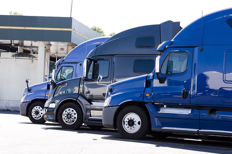 Business Insurance - Three Blue Trucks are Parked Near Each other on a Sunny Day