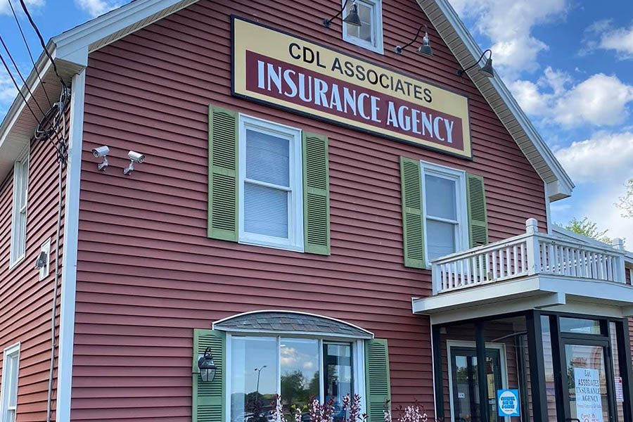 Gloversville, NY - Angled View of the Front of CDL Associates Insurance Agency Displaying Red Wood