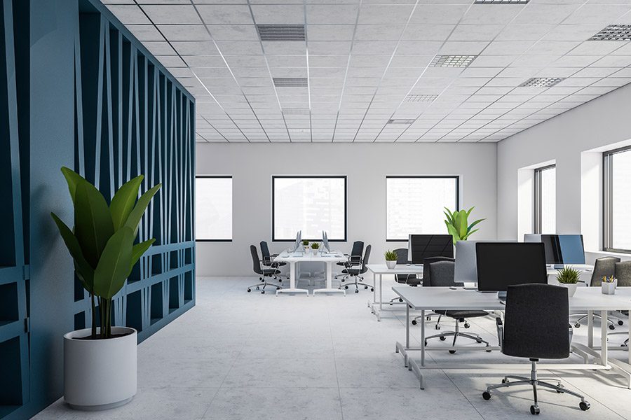 Specialized Business Insurance - Modern Office With Office Desks and Chairs With a Dark Blue Meeting Room