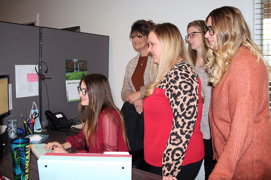 About Our Agency - CDL Associates Insurance Agency LLC Team Standing Together Looking at a Computer